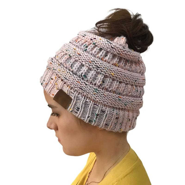 Asian Women gifts wearing a light pink warm hat with hairdo in a messy bun