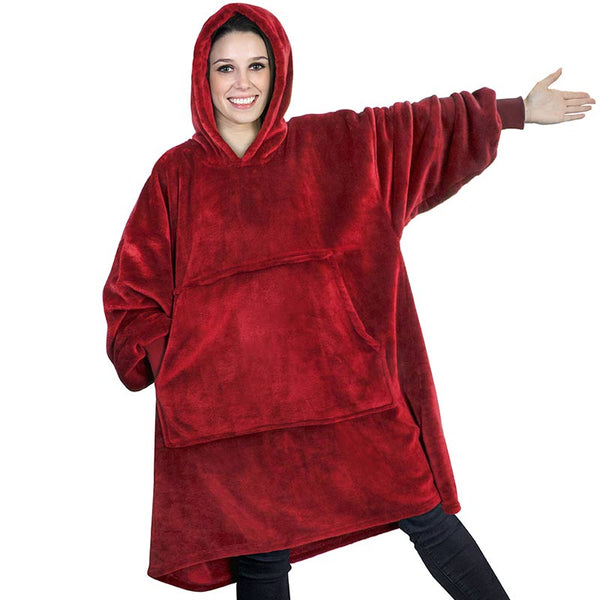 Brunette model wearing a red velvet pullover hoodie with sleeves covering arms as she points 