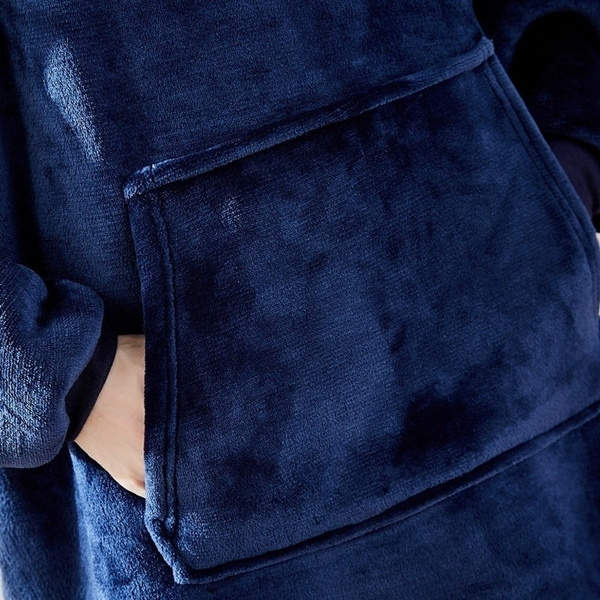 Close up shot of 100% polyester microfiber of blue pullover jumper with hands in large pockets
