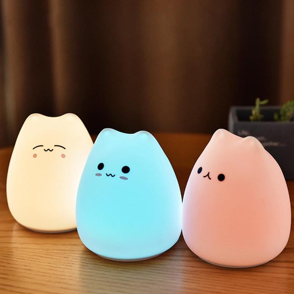 Squishie cute adorable cat light table lamp with three different hues sitting on a table